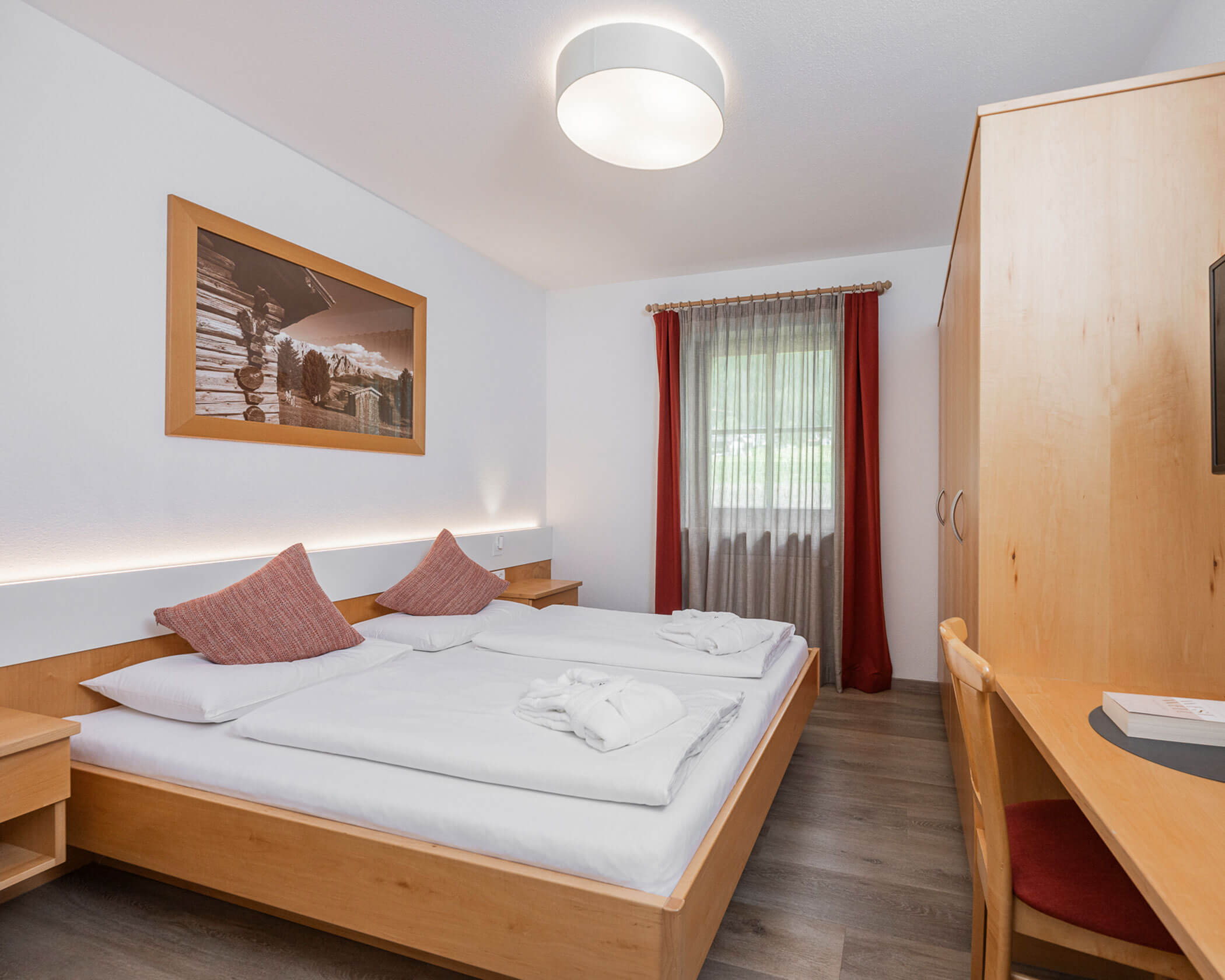 Schlafzimmer mit Doppelbett, Kleiderschrank und Schreibtisch im Apartment Typ C - Hotel Anewandter
