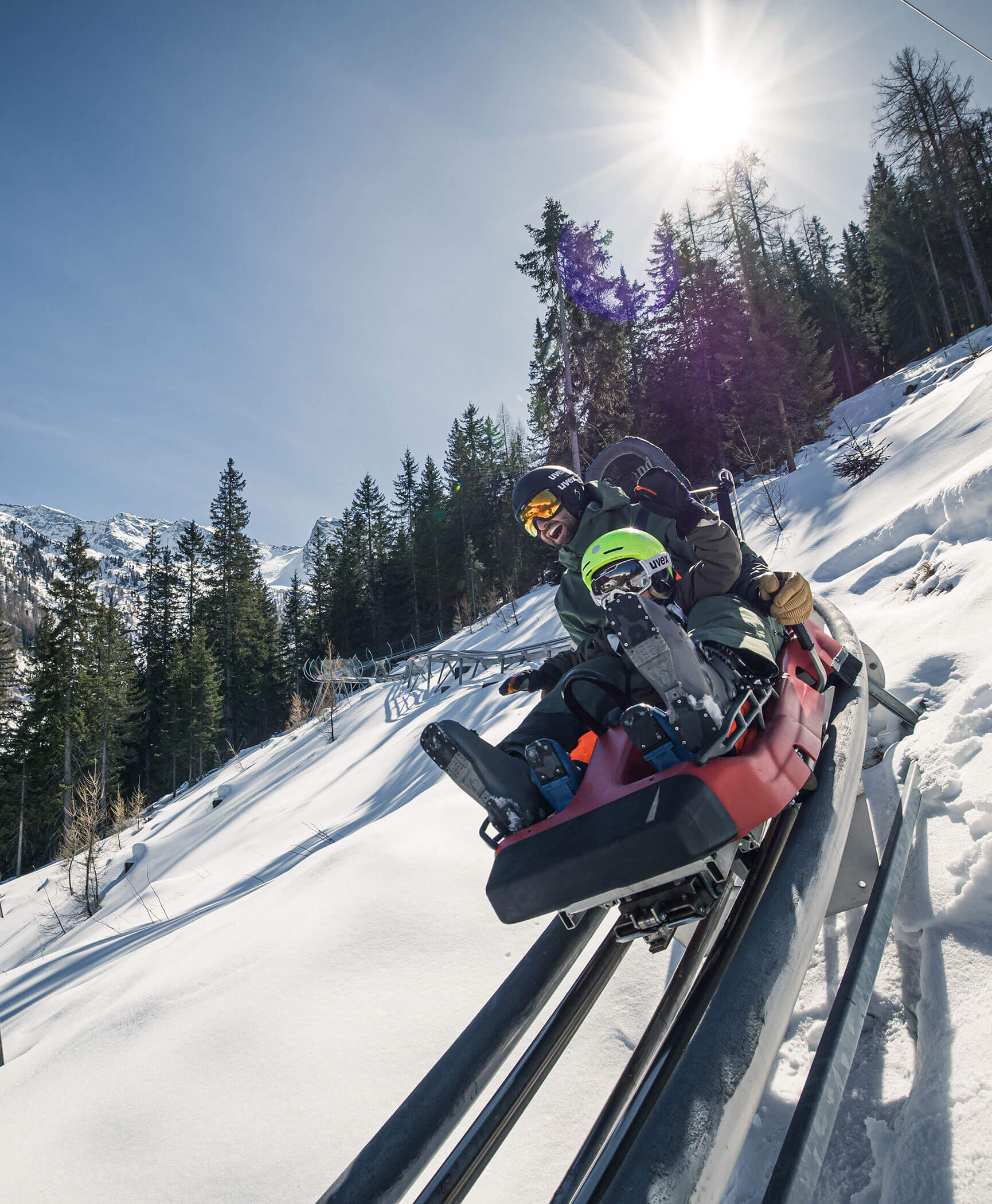 Un padre e suo figlio sulla pista da slittino estiva in inverno - Hotel Anewandter